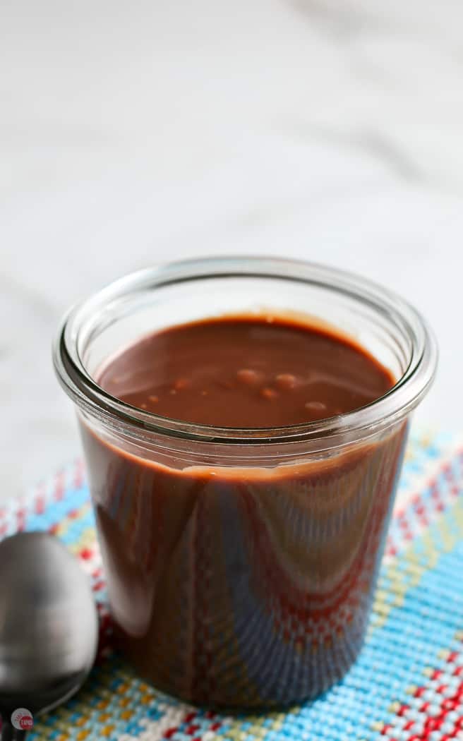 clear jar of fudge sauce