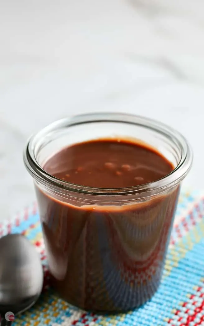 clear jar of fudge sauce