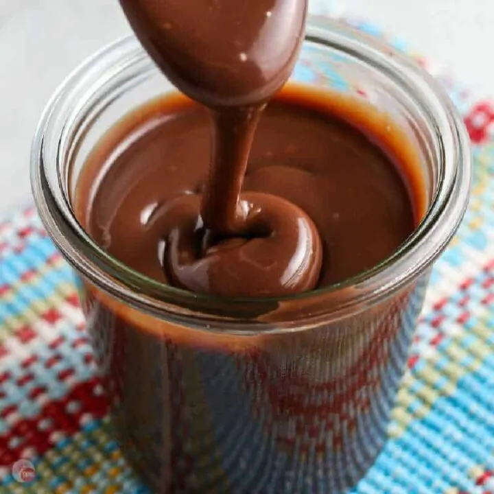 square picture of chocolate sauce in a clear jar