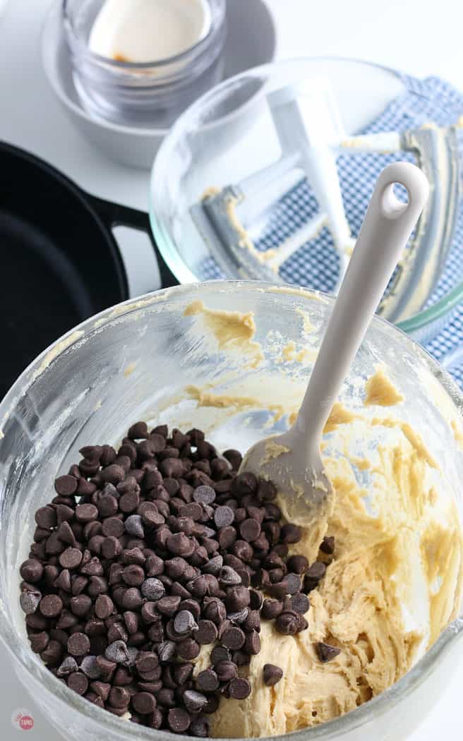 chocolate chips being stirred into dough