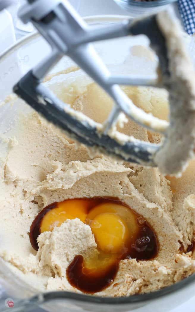 eggs and vanilla in cookie dough in a clear mixing bowl