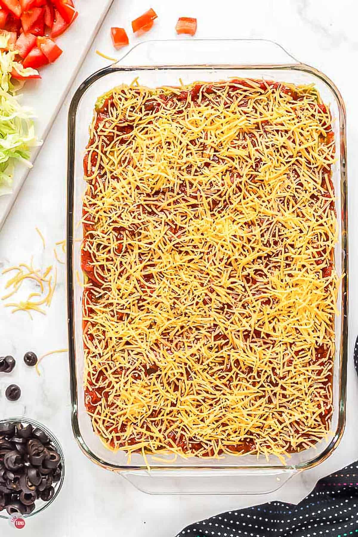 glass dish with salsa and sprinkled with cheese
