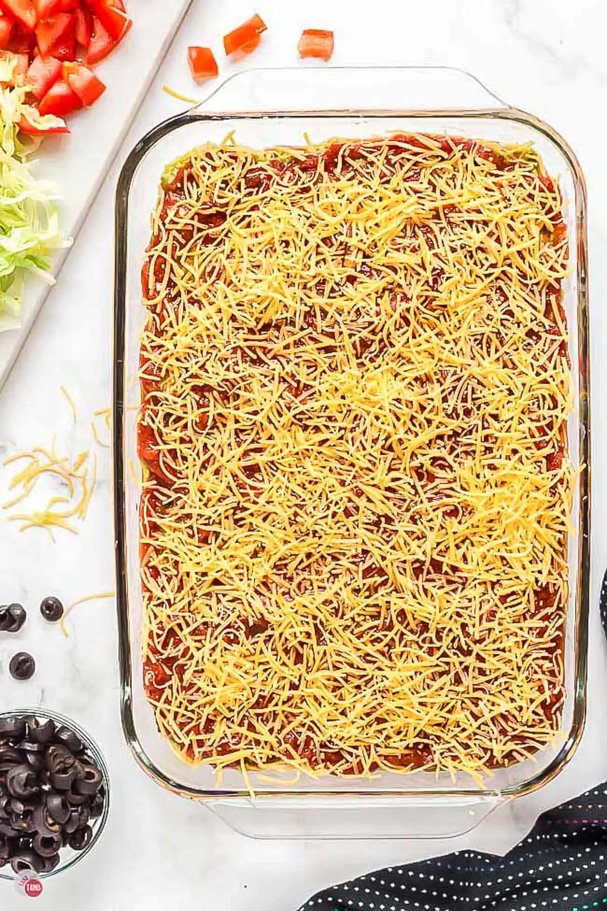 glass dish with salsa and sprinkled with cheese
