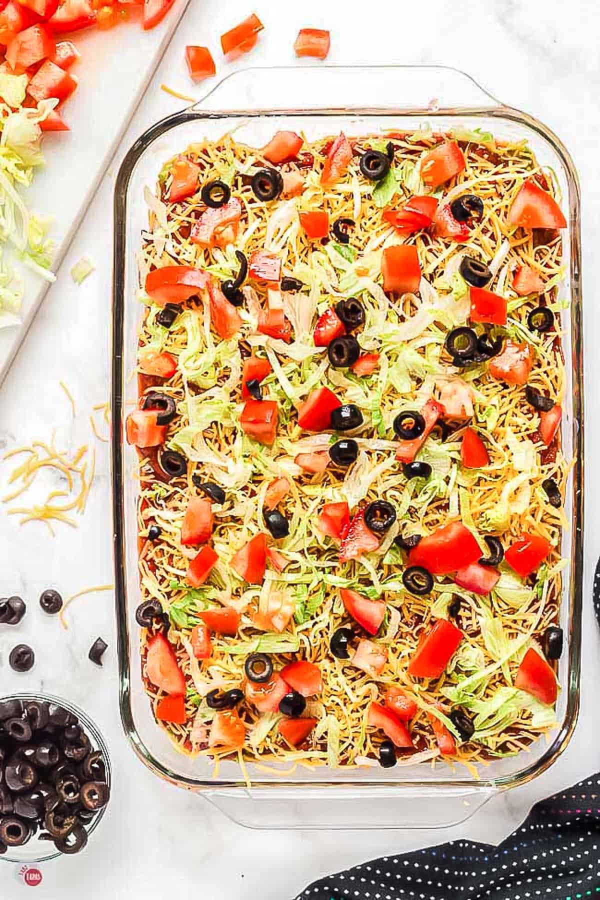 9x13 glass baking dish filled with 7 layer dip