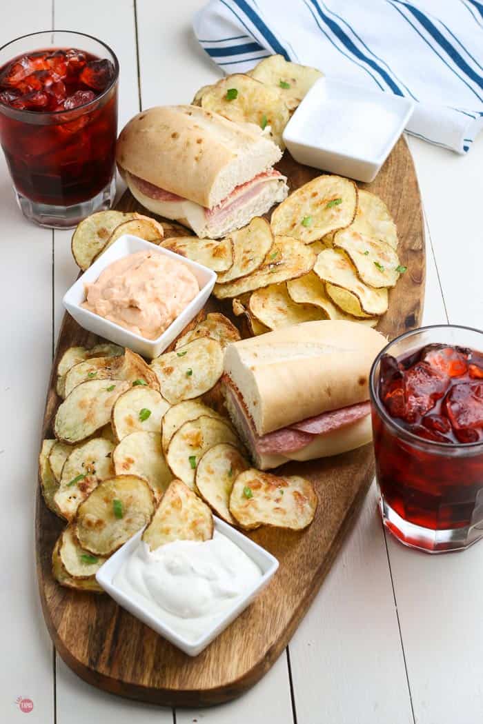 overhead picture of potato chips and sandwiches on a board