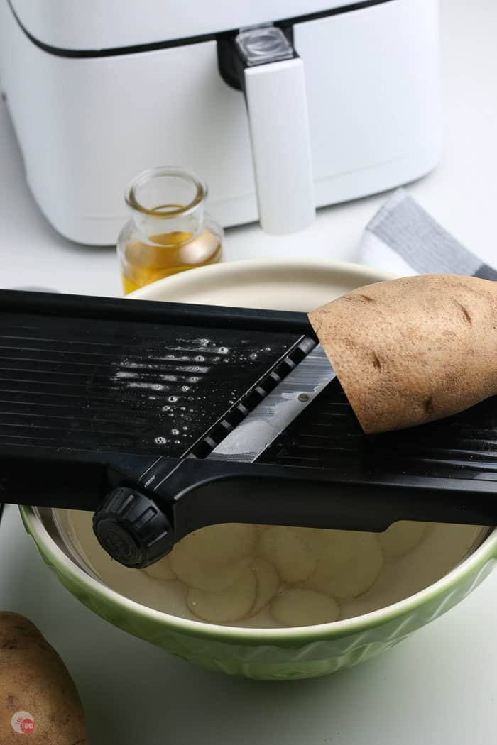 potato on a mandolin slicer