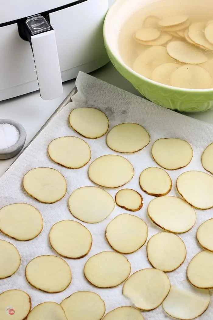 potato slices drying on paper towels