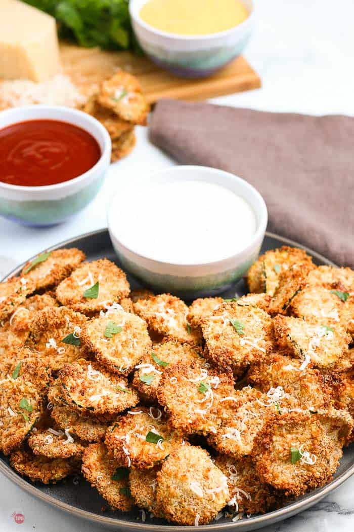 grey plate with fried zucchini chips and bowl of ranch dip