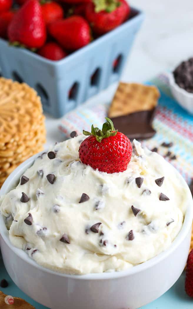 cannoli dip in a white bowl with a strawberry in it