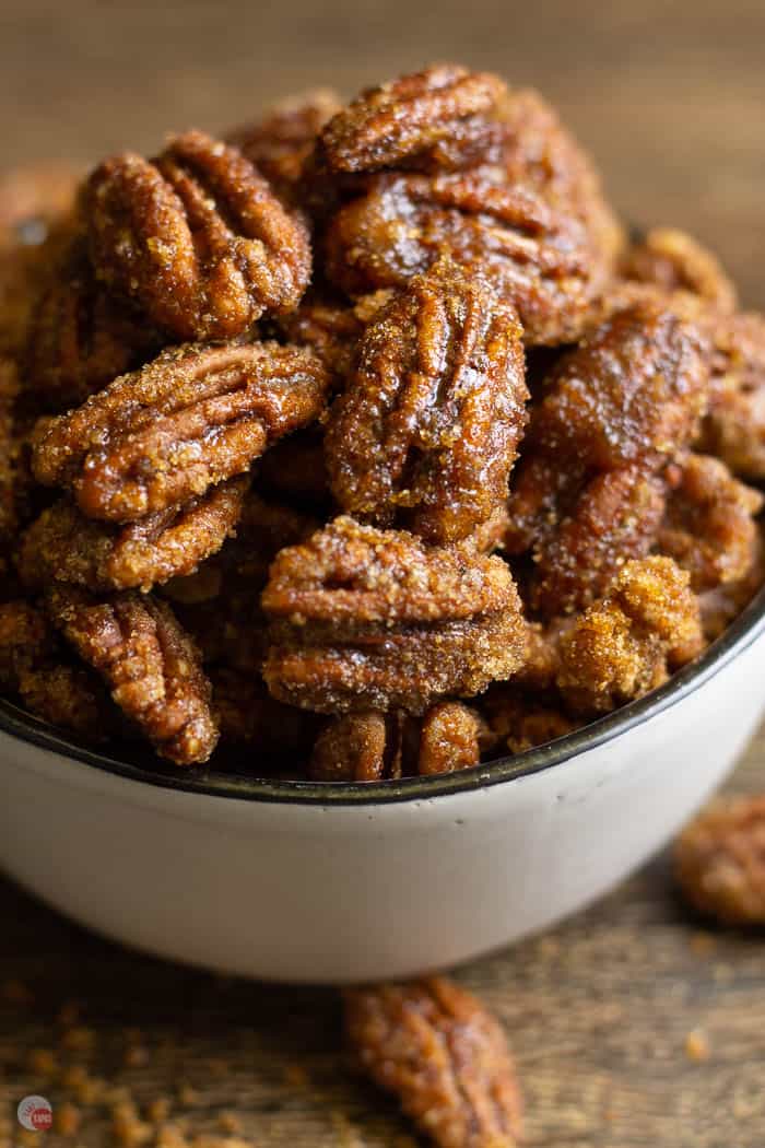 close up of candied nuts in a white bowl