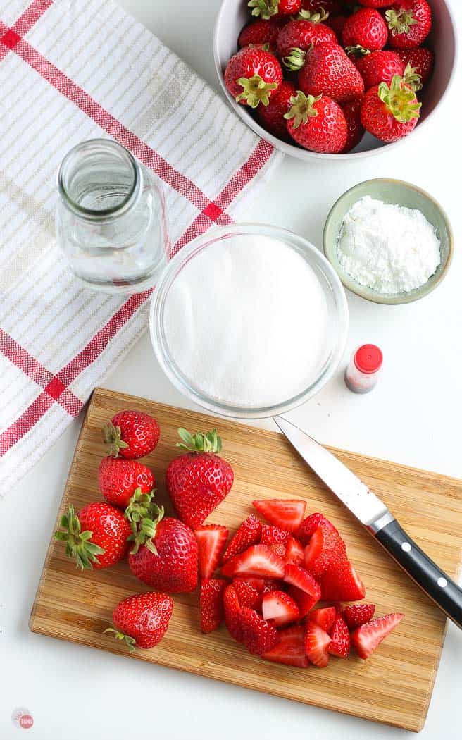 overhead pic of cut berries and sugar