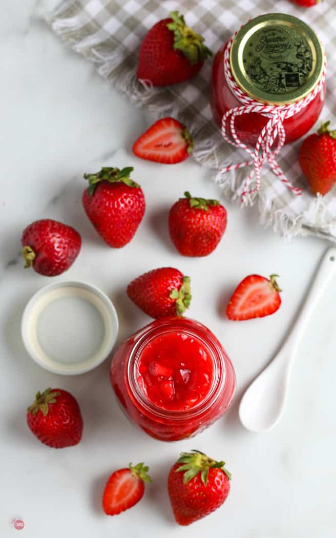 overhead picture of jar of sauce and fresh strawberries