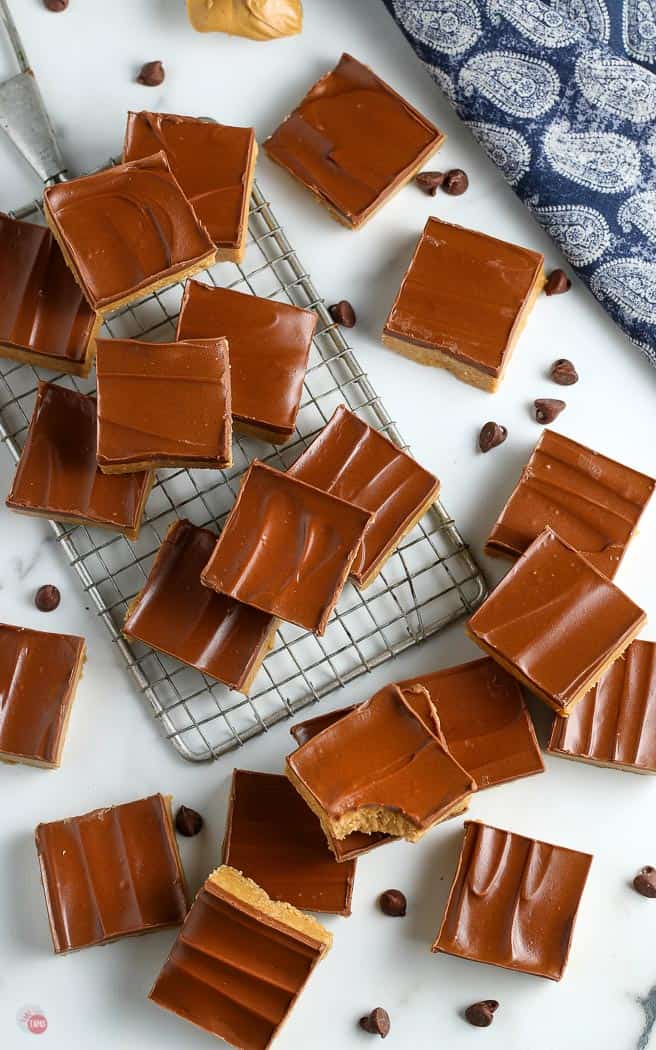peanut butter bars spread on a shite backdrop