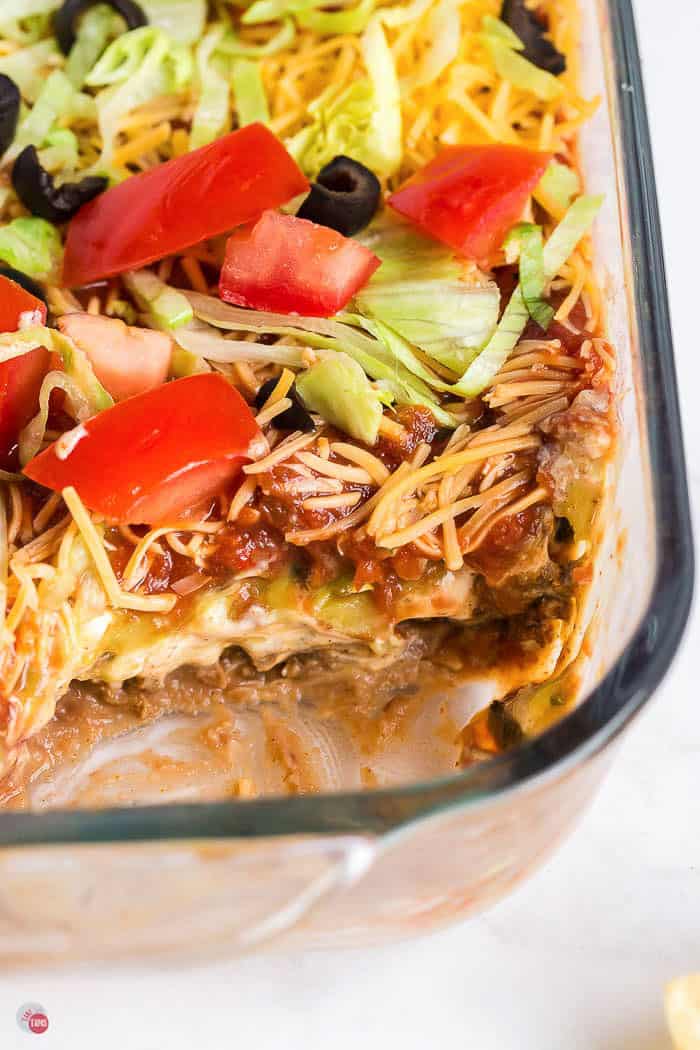 dish of taco dip with a section scooped out