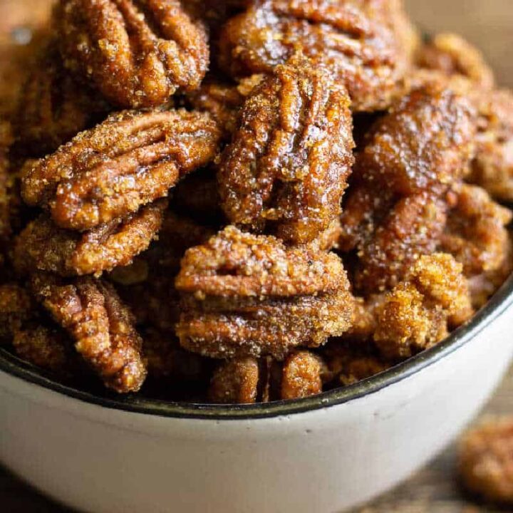 square photo of candied pecans in a white bowl for recipe card