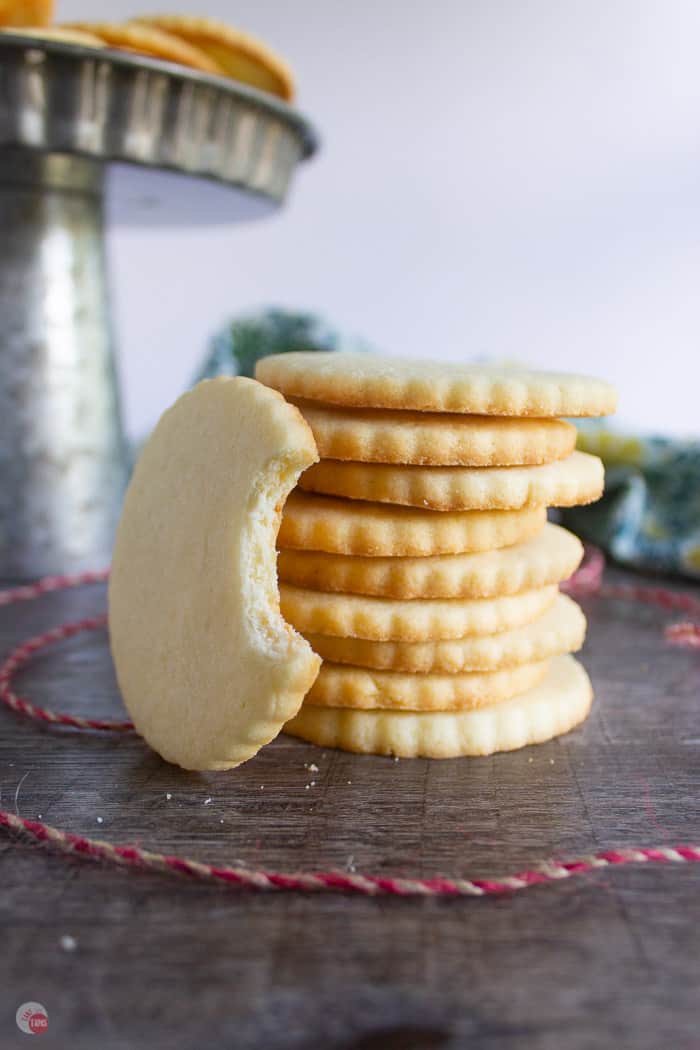 stack of almond shortbread cookies with a red string in front of them