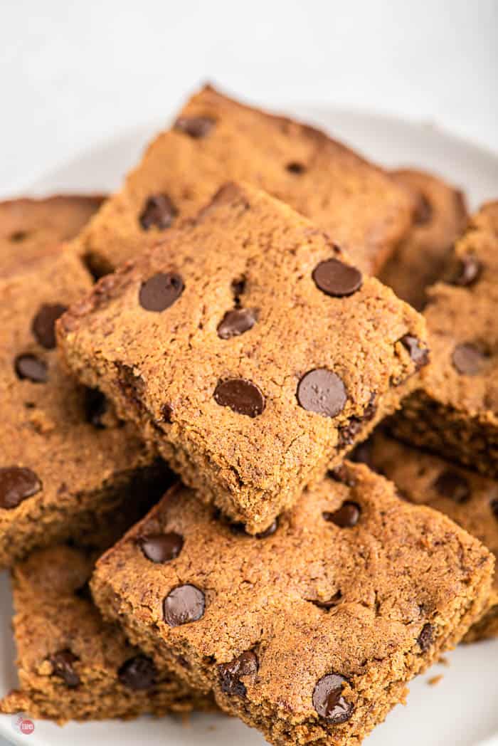 stack of blond brownies on a white plate