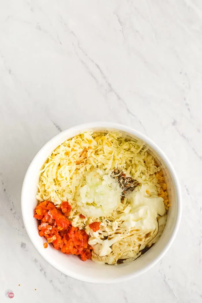 white bowl with pimento cheese spread ingredients unmixed