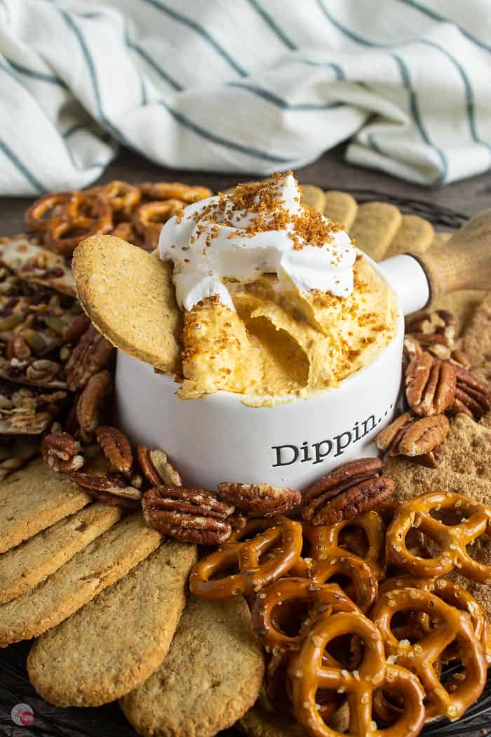 white bowl of dip in a tray of crackers