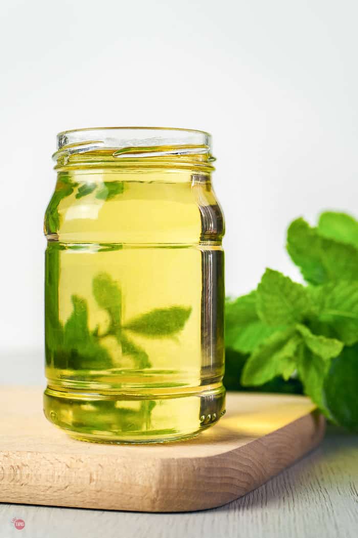 jar of syrup with mint behind it