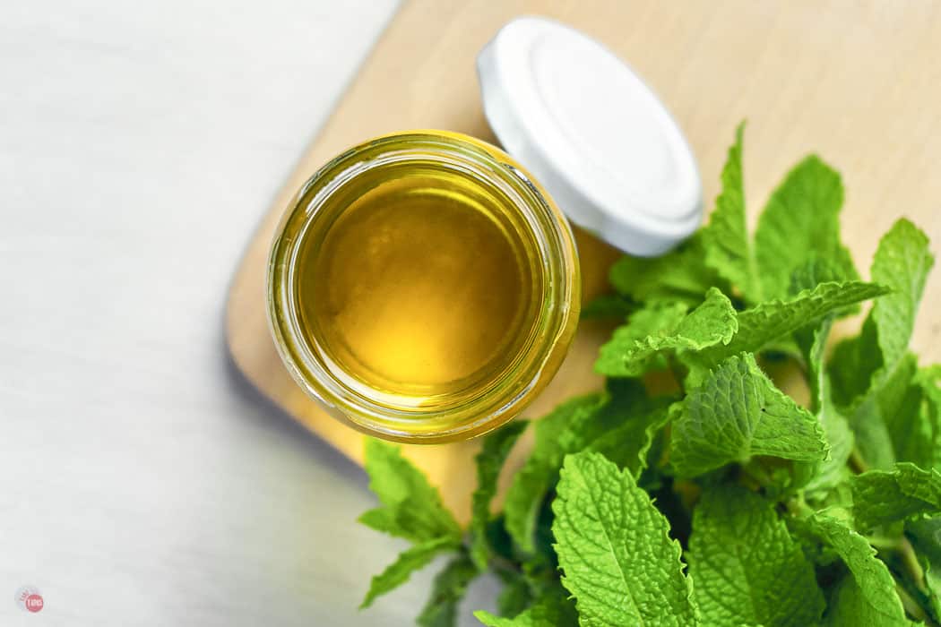 overhead picture of jar of yellow syrup and mint