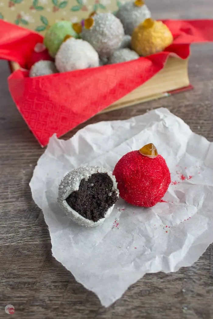 two oreo truffles on parchment paper