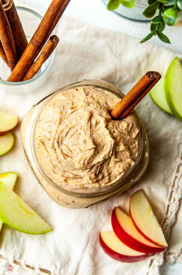 overhead shot of dip with apple slices and a cinnamon stick