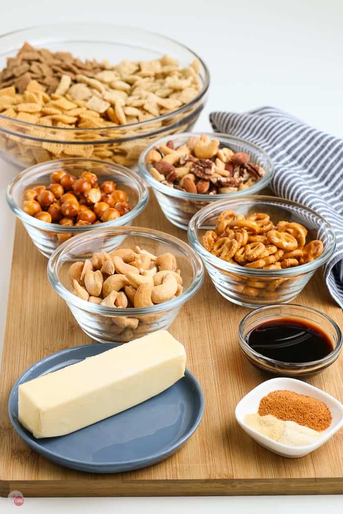 ingredients in individual bowls for chex mix oven baked