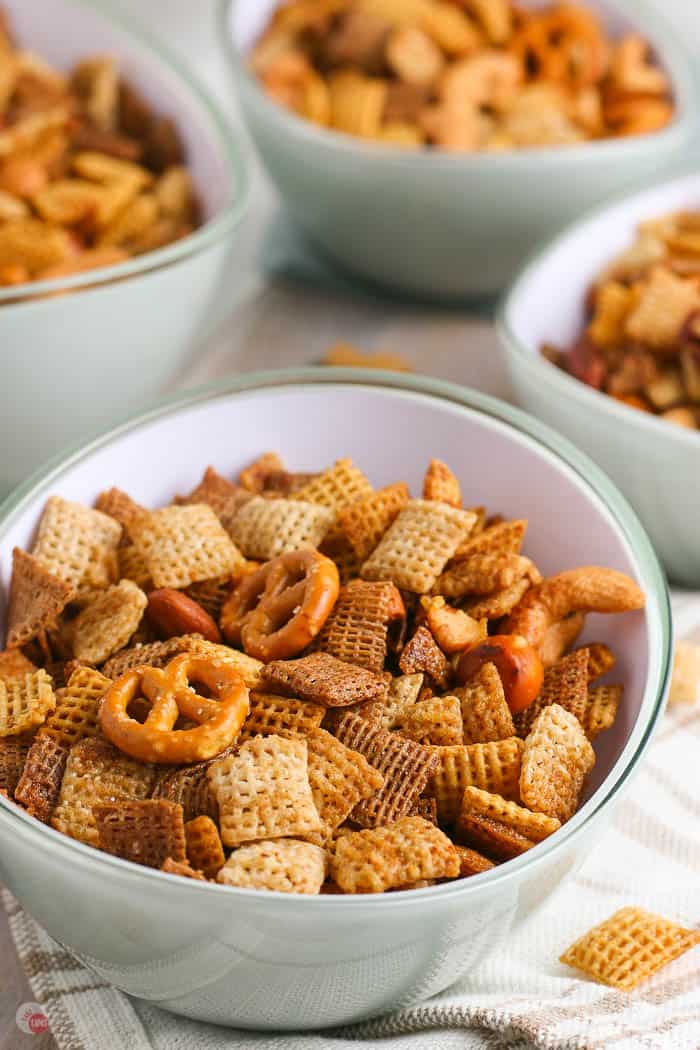 side view of 4 bowls of snack chex mix