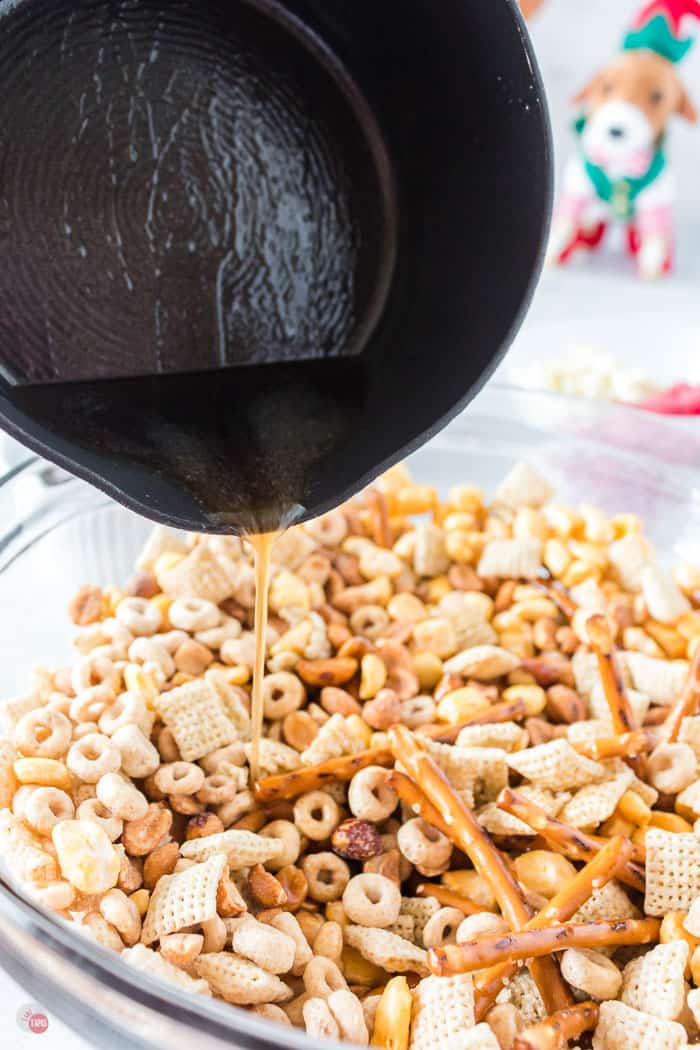 pot pouring topping on snack mix