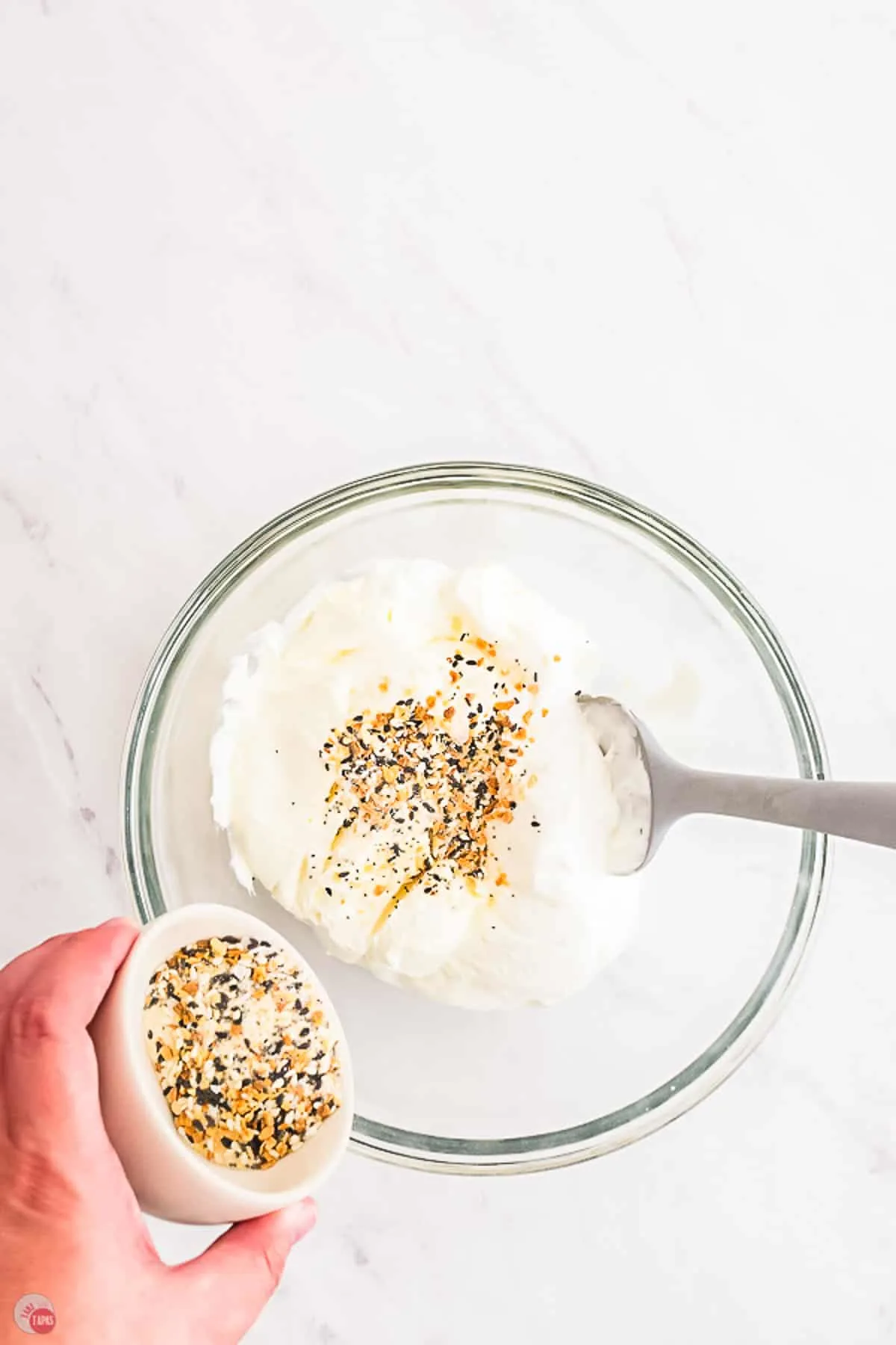 spoon mixing seasoning into cream cheese