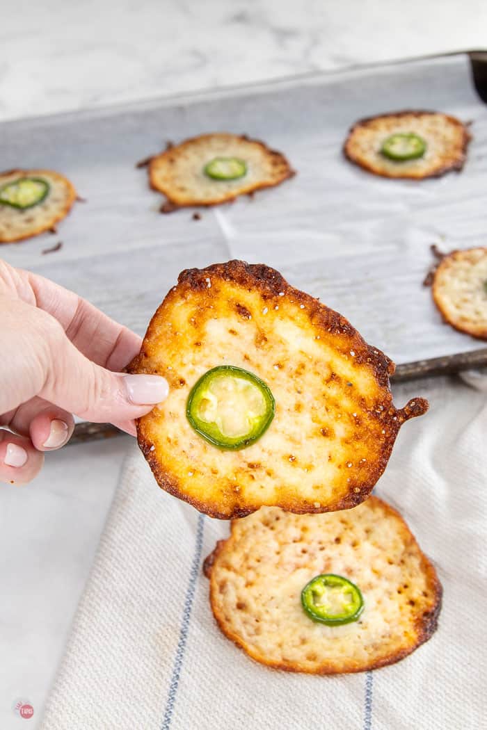 hand holding baked cheese round