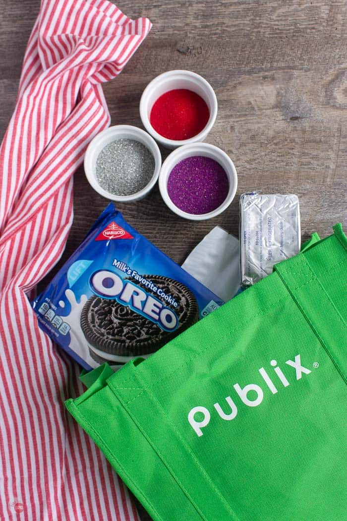 green bag with OREO cookies, cream cheese, and sprinkles