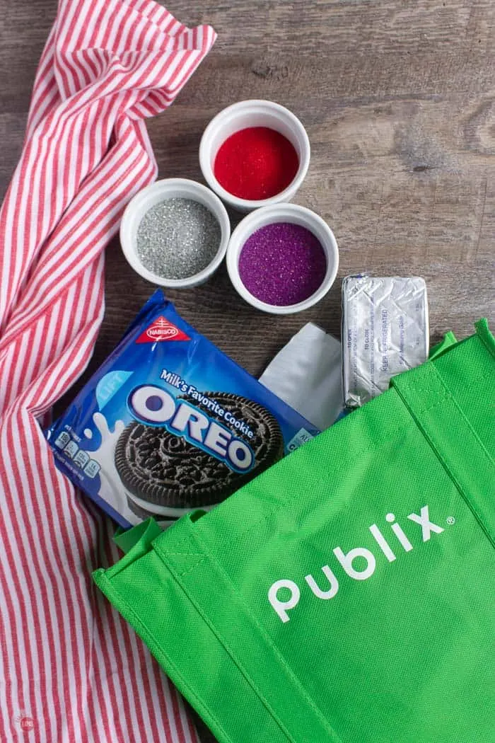 green bag with OREO cookies, cream cheese, and sprinkles