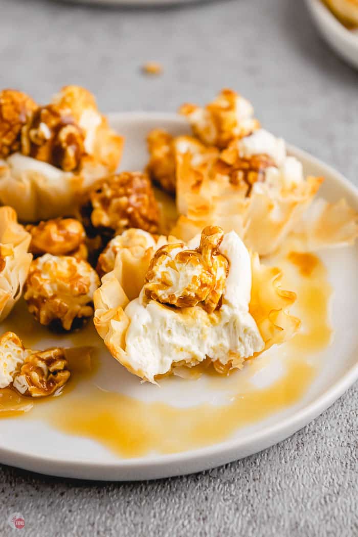caramel corn phyllo cup on white plate with bite taken out of it