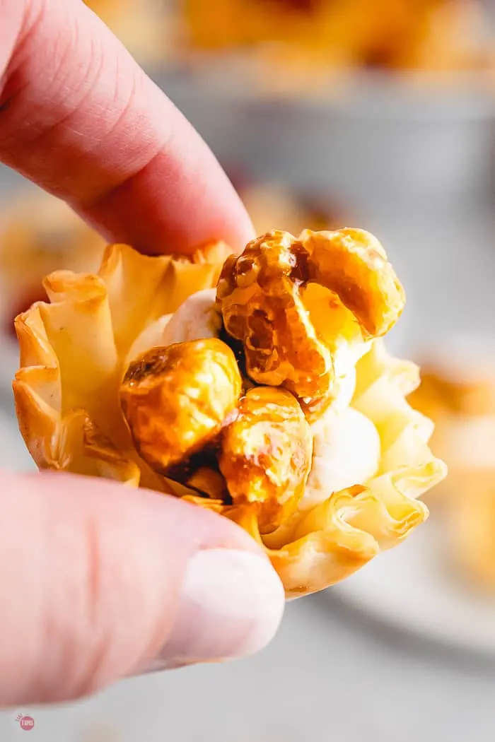 single caramel corn phyllo cup in a hand