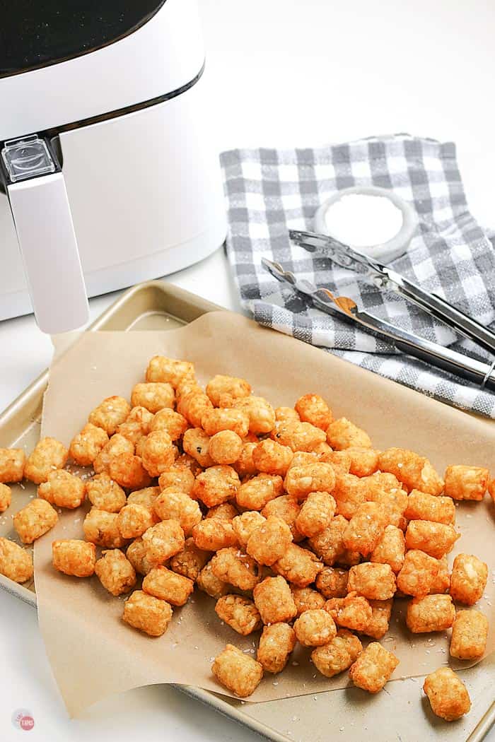 cooked tots on a platter with parchment paper