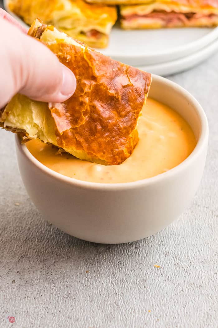 slider dipping in a bowl