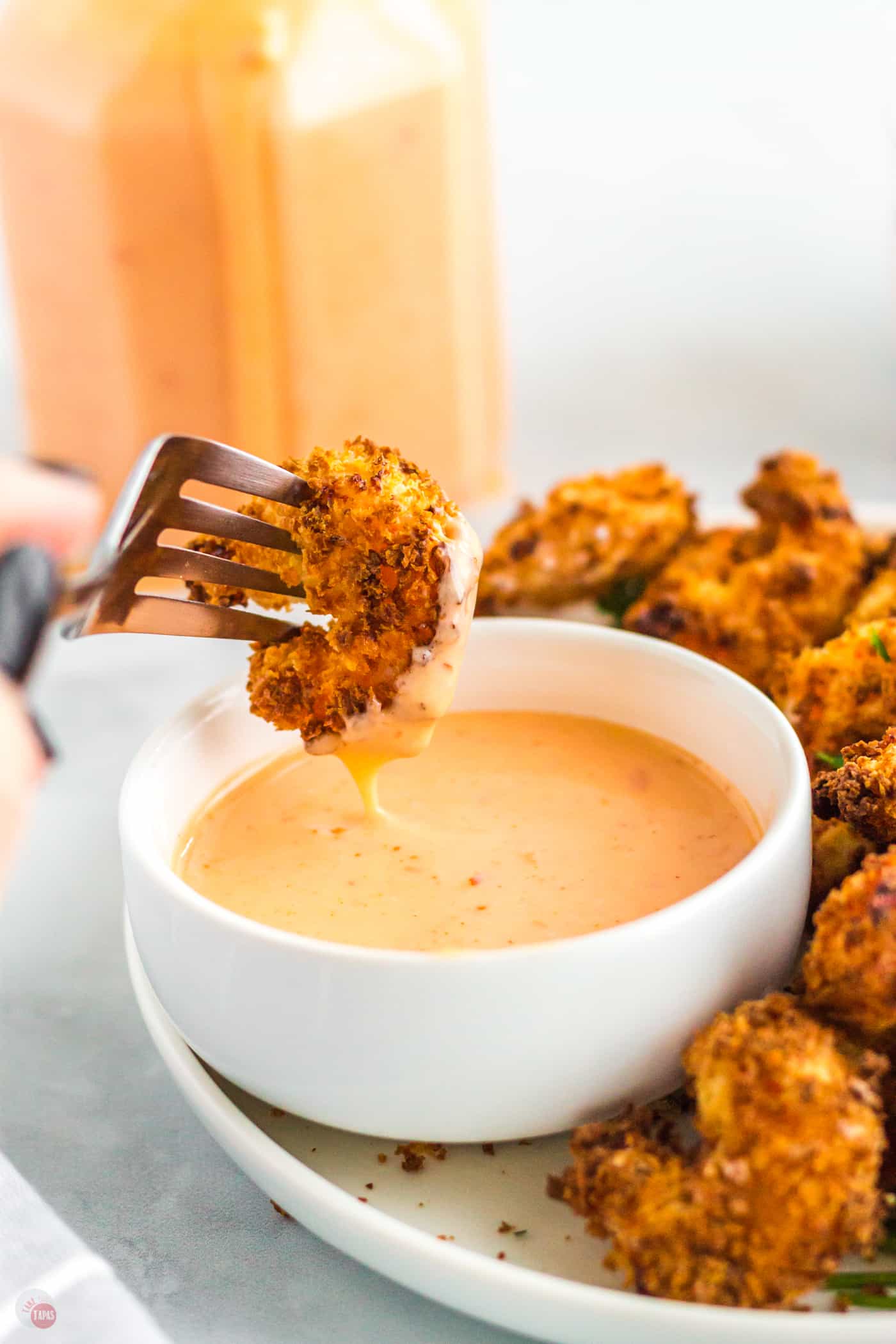 fork and shrimp dipping in bowl