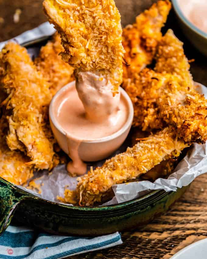 chicken tender dipping in sauce