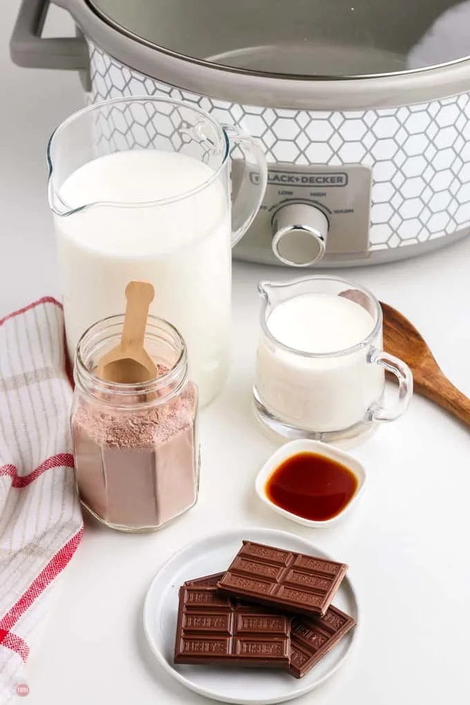 hot cocoa ingredients in front of a crock pot