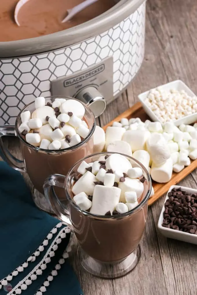 two mugs of hot cocoa with crockpot