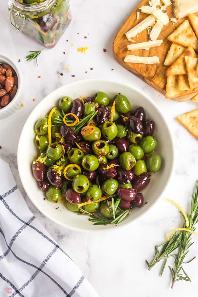 bowl of marinated olives with a cheese board