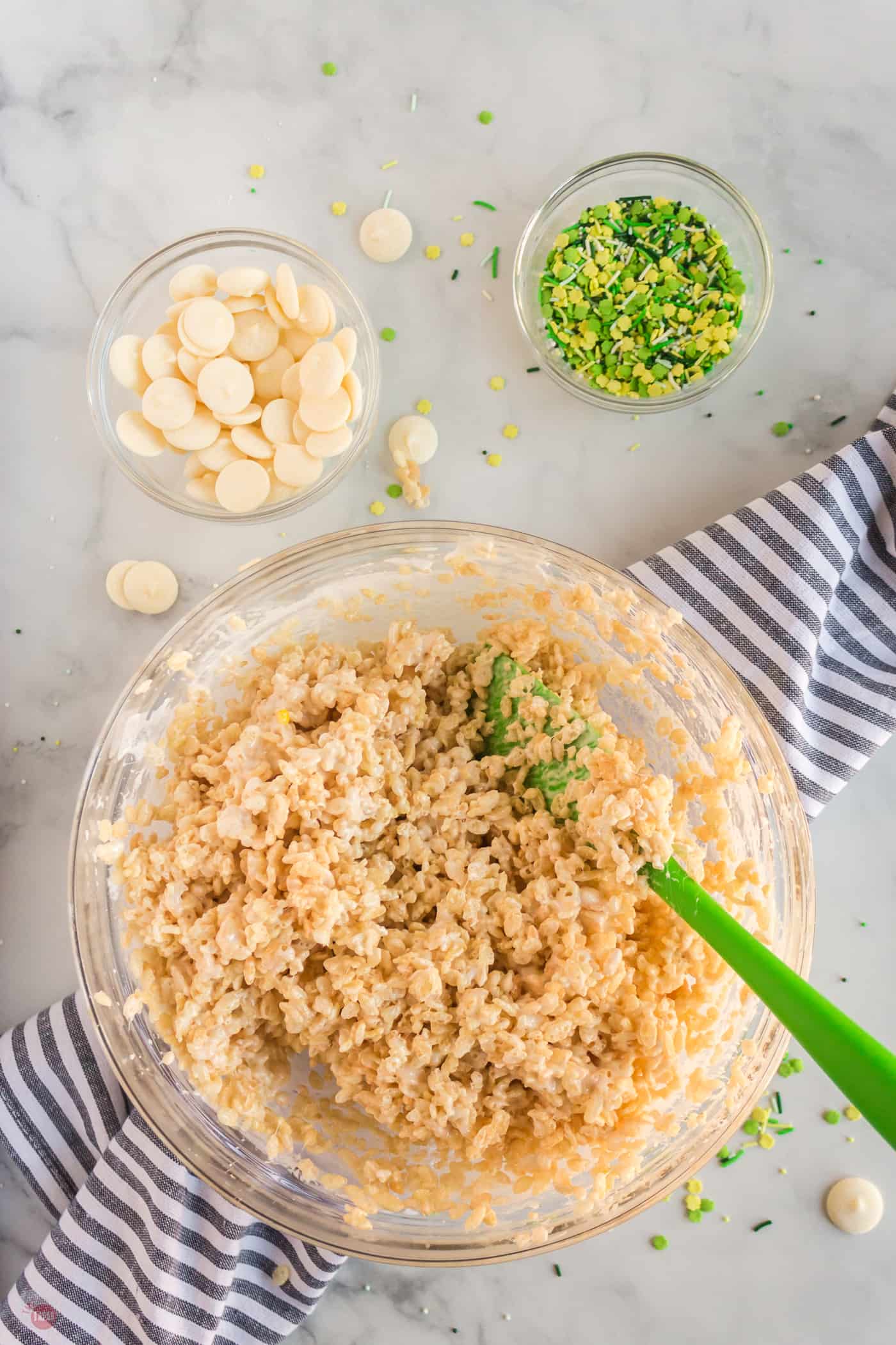 rice krispie treats being mixed in a bowl