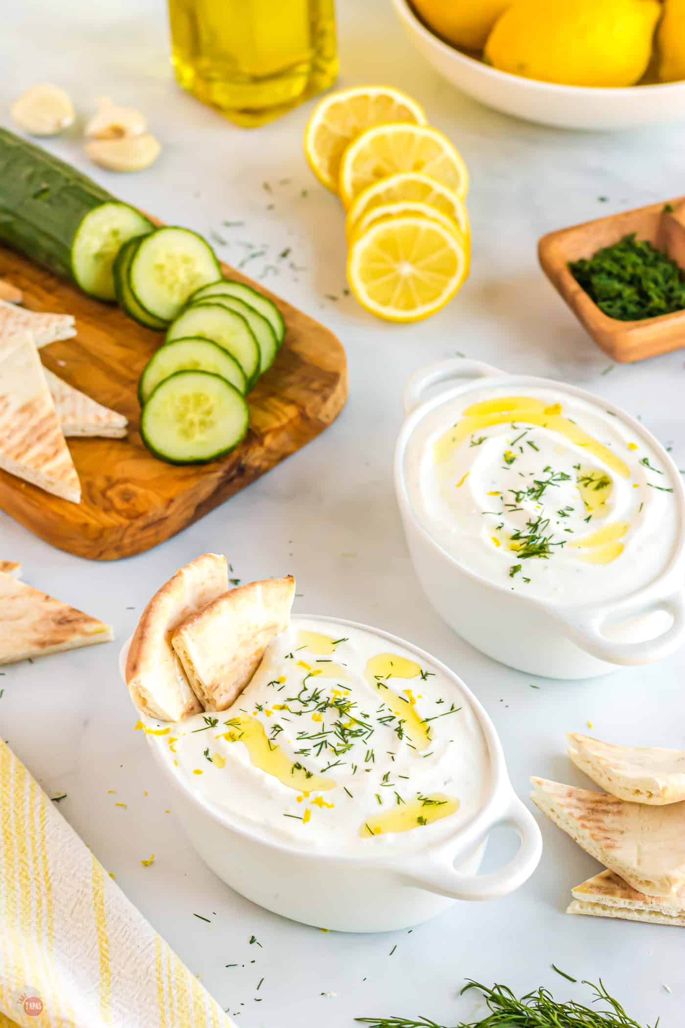 bowls of greek yogurt sauce with pita