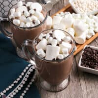 two mugs of hot cocoa with marshmallows