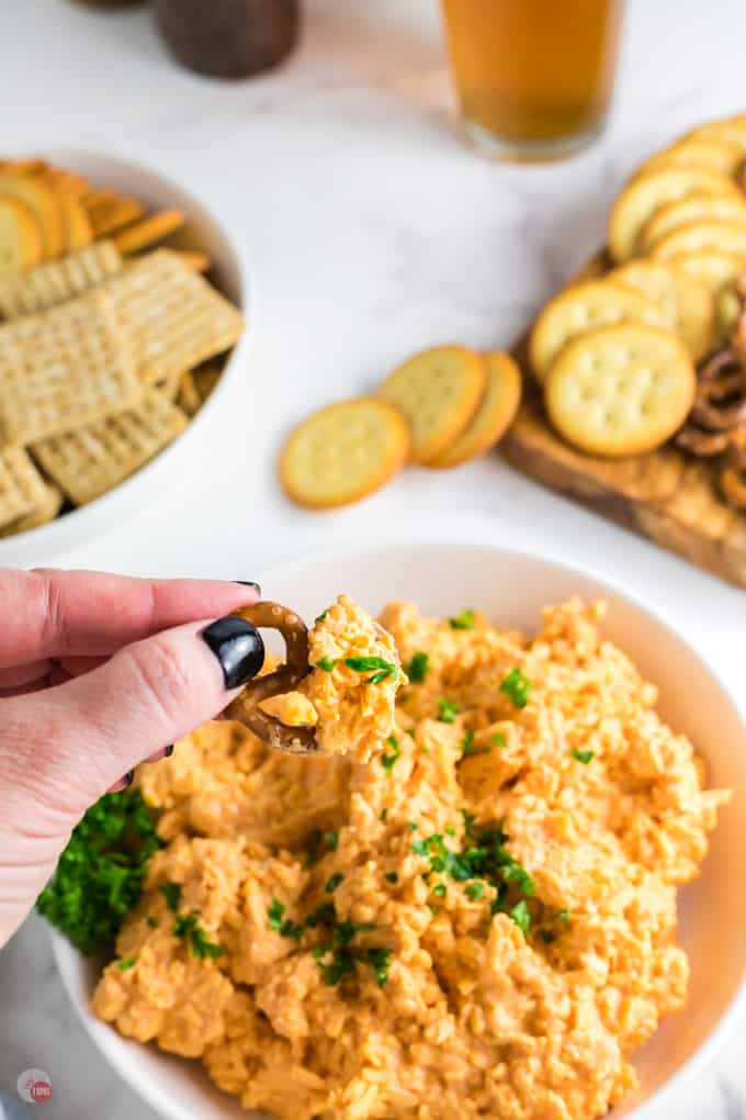 hand with pretzel and dip