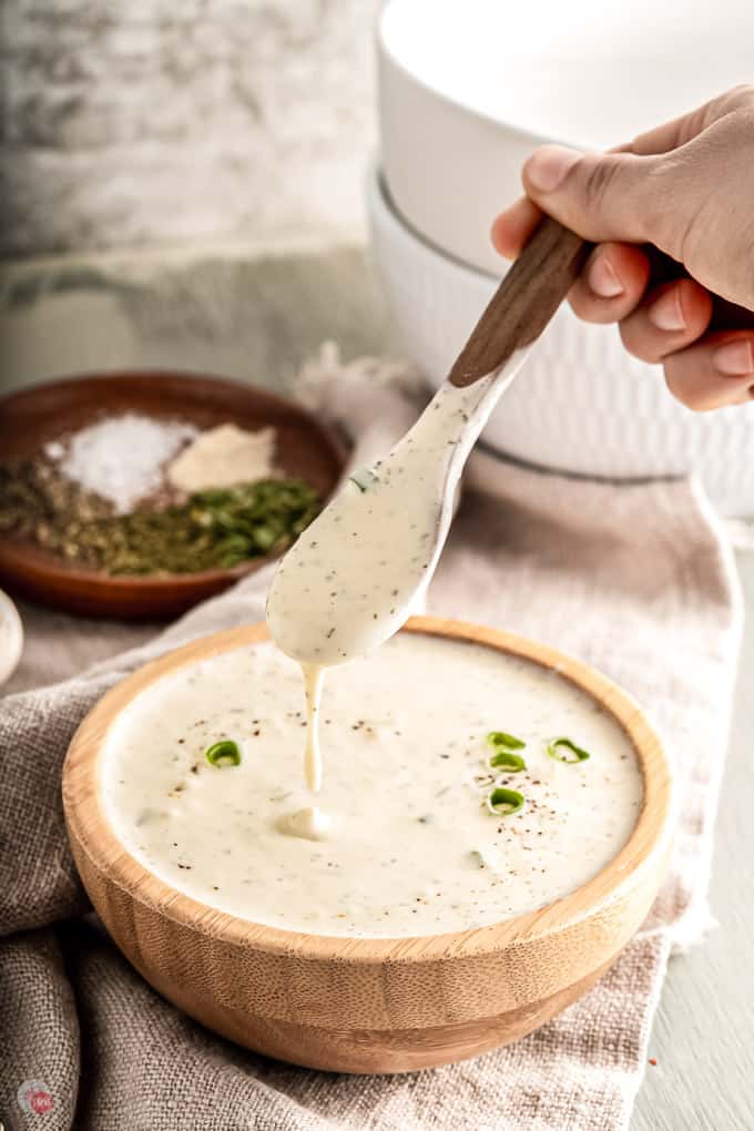 ranch sauce in a wood bowl with a spoon