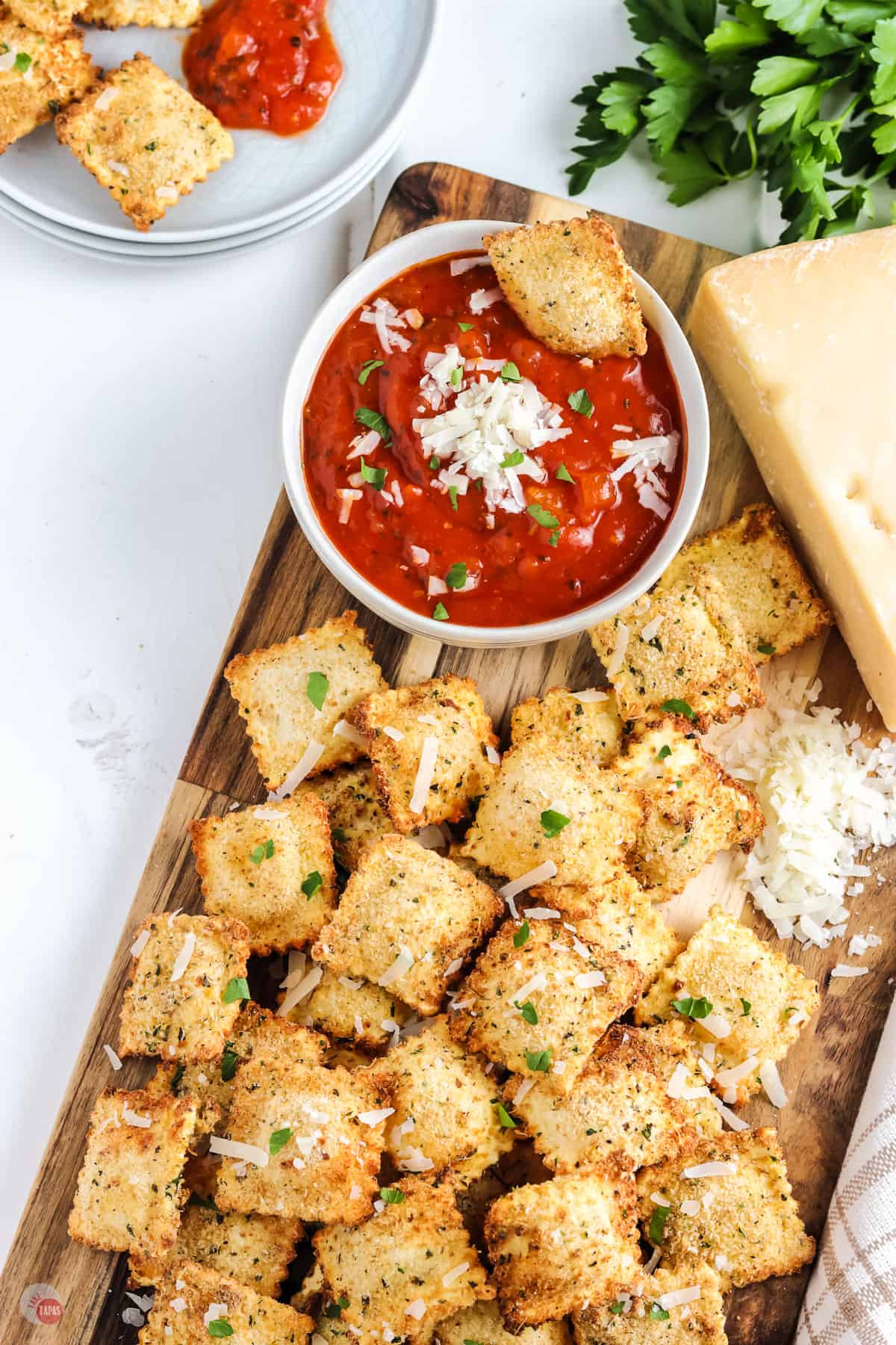 toasted ravioli on a cutting board