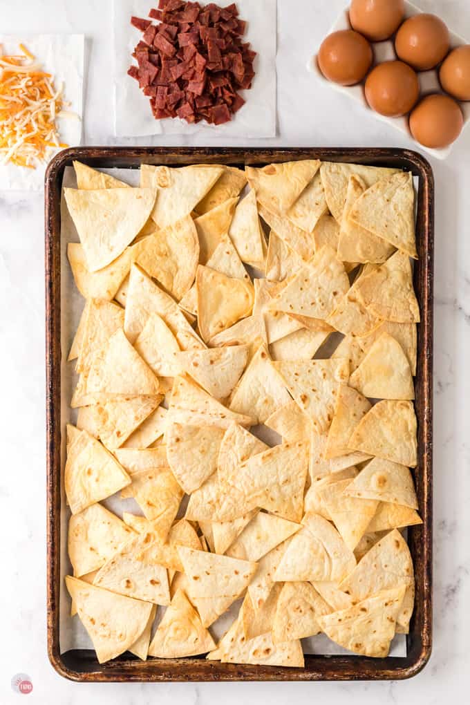 tortilla chips on a baking sheet